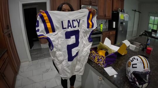 Kandace Washington holds up her son's jersey.