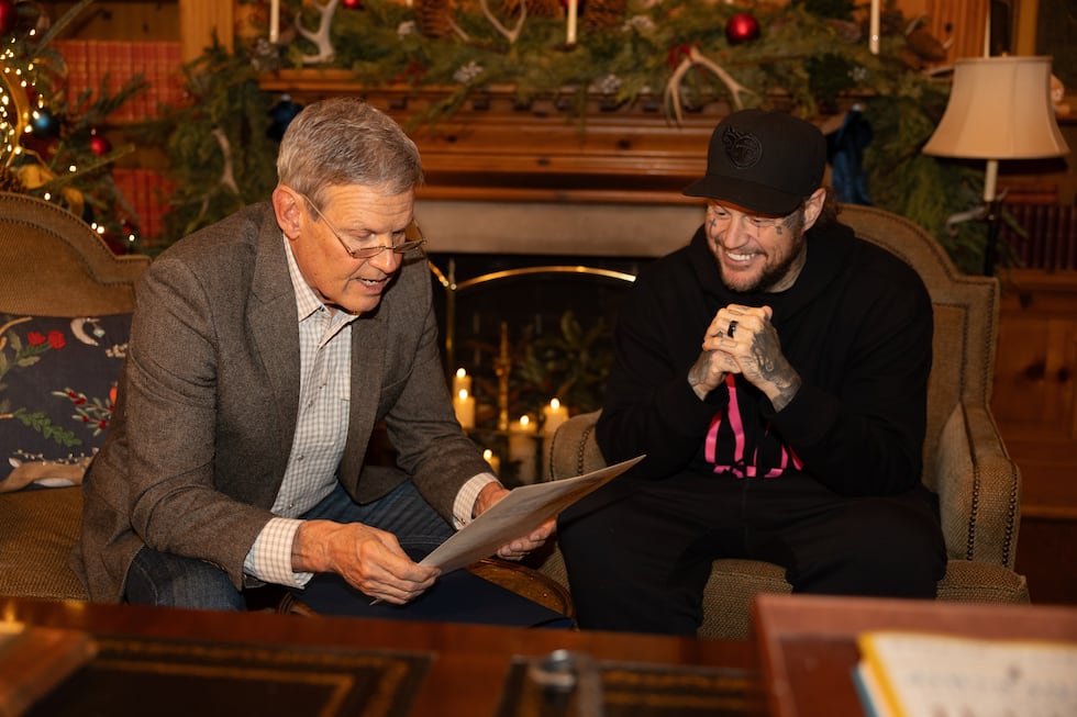 This photo provided by the office of Tennessee Gov. Bill Lee shows Gov. Bill Lee, left, giving...