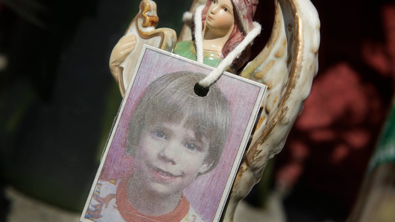 FILE - A photograph of Etan Patz hangs on an angel figurine, as part of a makeshift memorial...