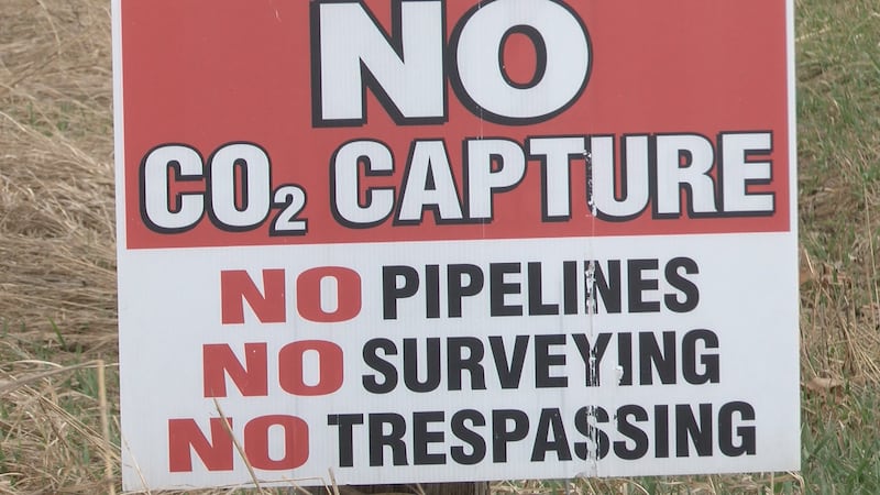 Signs like these are posted outside of the homes of people opposed to the carbon capture plan
